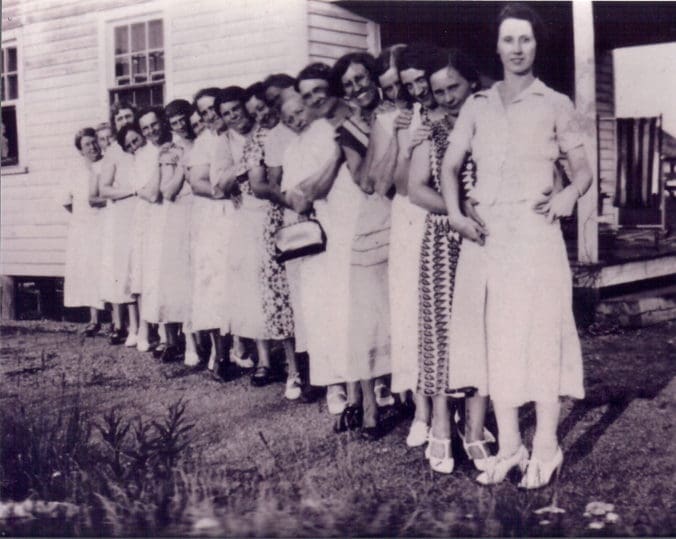 A Group of Women Lined Up for a Photograph
